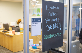 HCC wellness center. Signs reads "in order to do well you need to be well."