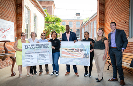 A photo of County Executive Calvin Ball outside of Savage Mill for his press conference to announce the launch of the new Savage Mill Bucks program offering visitors to the Mill a $10 business voucher.