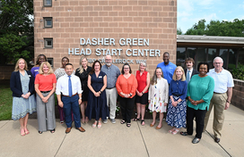 A photo of County Executive Calvin Ball and representatives from the Community Action Council and other outside Dasher Green Head Start Center. 