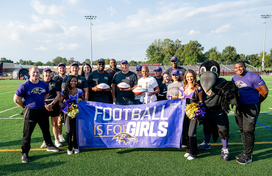 A photo of County Executive Calvin Ball with members of the Baltimore Ravens and Howard County Public School System during a press conference announcing girl flag football is coming to all  Howard County high schools.
