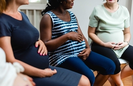 Diverse group of pregnant people in a support group