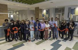 County Executive Calvin Ball with Howard County Government employees, fellow local elected officials, and community members celebrating the red ribbon being cut to mark the opening of the new addition to Recreation & Parks' North Laurel Community Center.