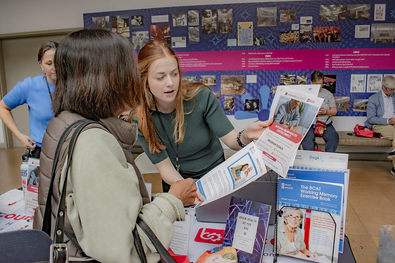 Female vendor and female participant looking over papers together
