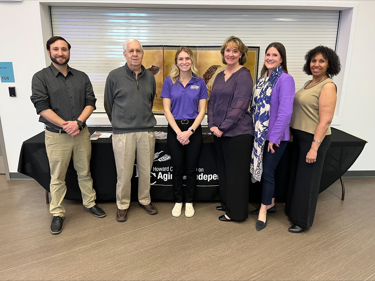 Group of three commission on aging members standing together with an OAI staff person and Alzheimer's association staff person for a posed photo. There are two men on the left and four females to the right of them.