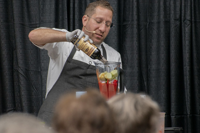 Chef Egg pour ingredient into blender to make gazpacho