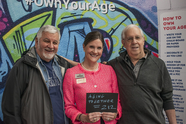 Three commissioners posing. Two male and one female in the middle.
