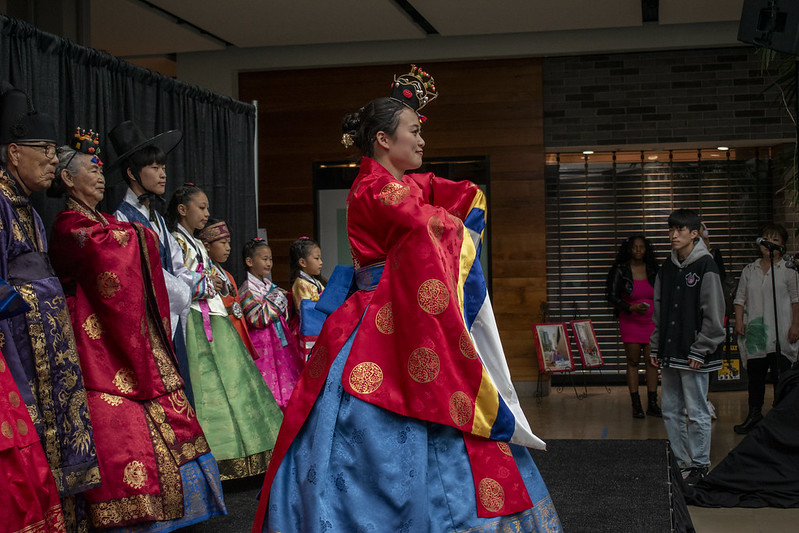 Woman dressed in traditional Korean attire. Side angle view