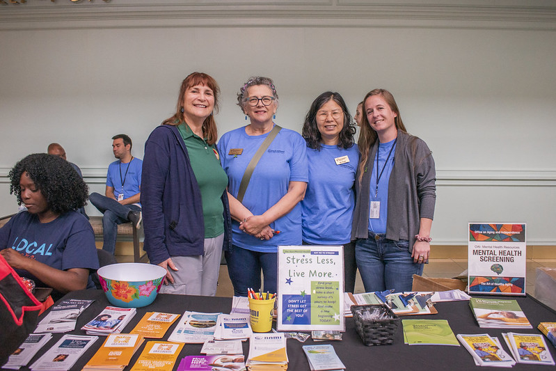 Group of 4 female staff members posing at their table