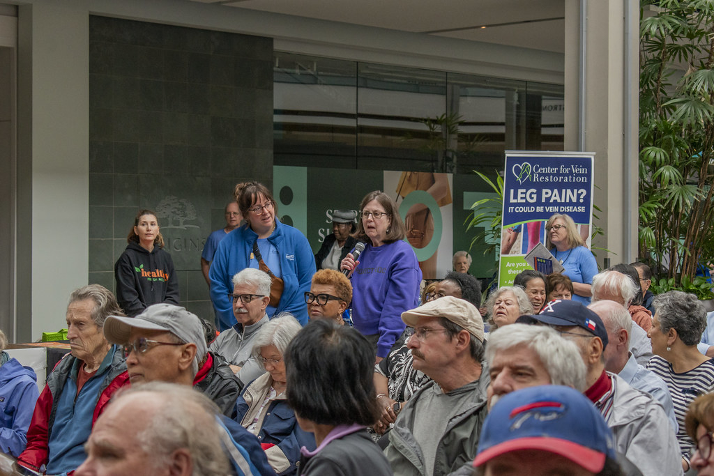 Person standing up with microphone asking question to the keynote.