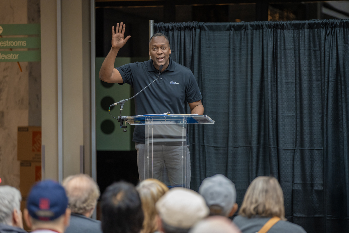 Calvin Ball at podium raising his right hand