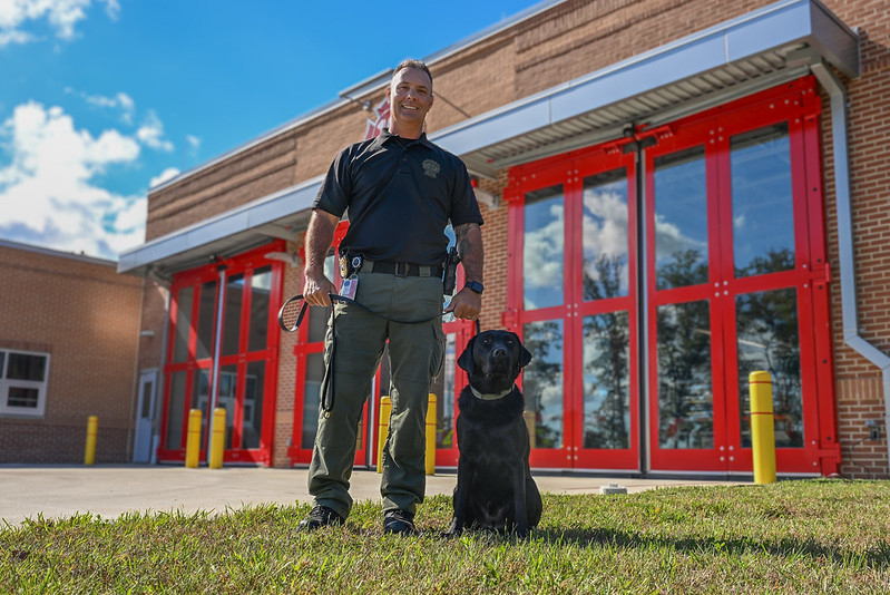 A photo of Department of Fire and Rescue Services Captain Craig Matthews and the department's new arson dog Beacon out front of Station 12.