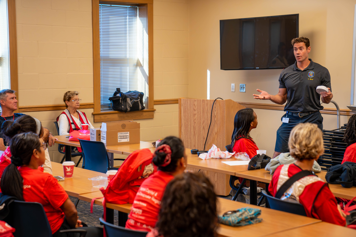 FF Sinz talks to Red Cross employees about smoke alarms