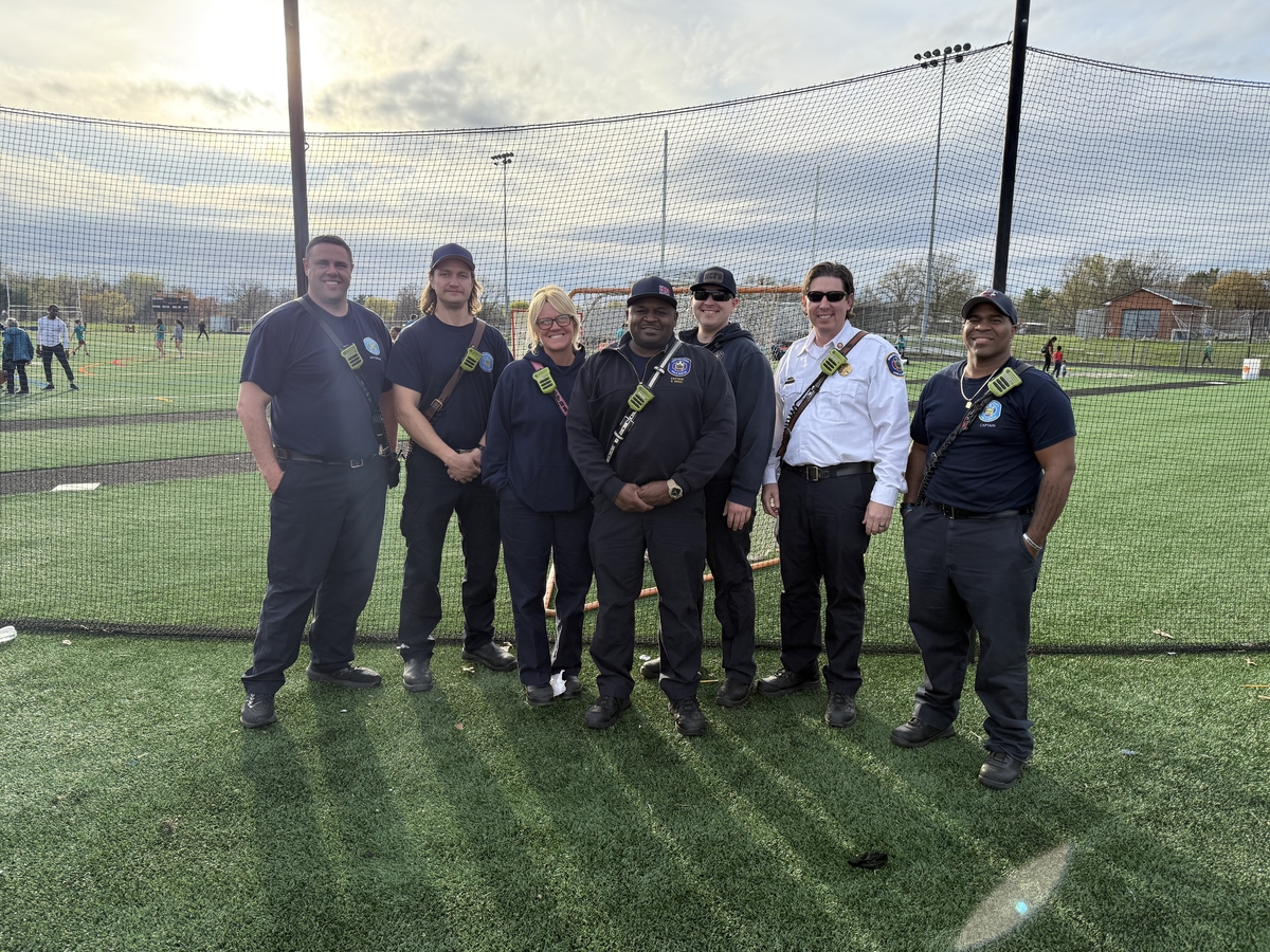 Firefighters standing on sports field