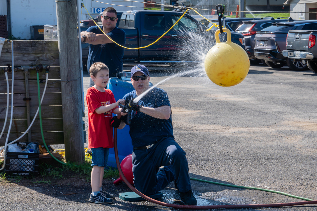 Shooting water from a fire hose against a ball