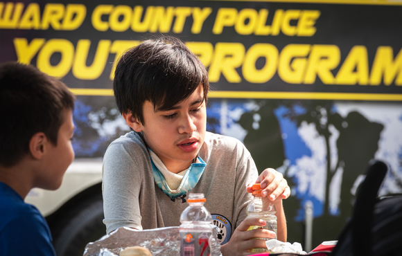 Kids playing in front of Howard County Police Youth Program Van