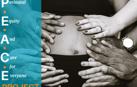 hands holding pregnant belly