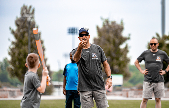 Officer throws ball at batter