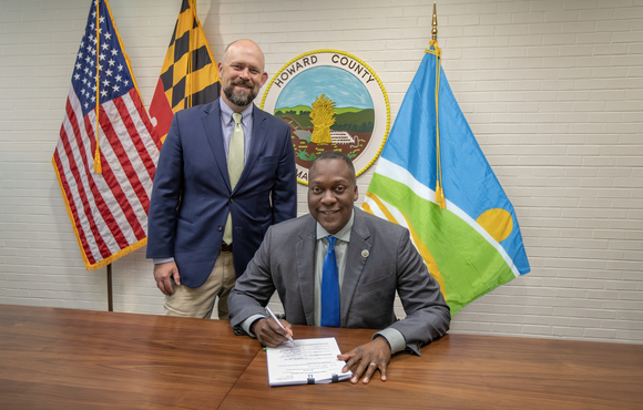 A photo of County Executive Calvin Ball getting ready to sign legislation establishing the county's new flag.