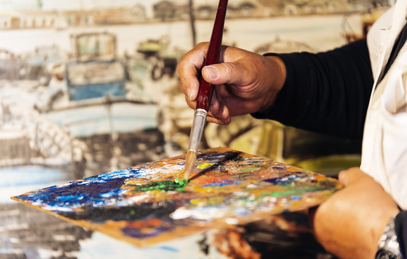 close up of male artist painting oils