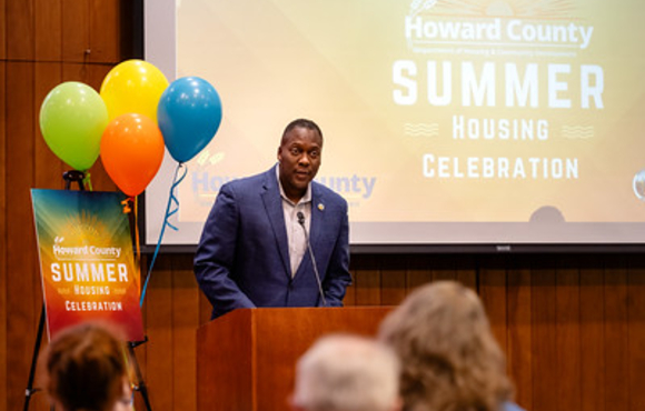 County Executive at podium at Summer Housing Celebration