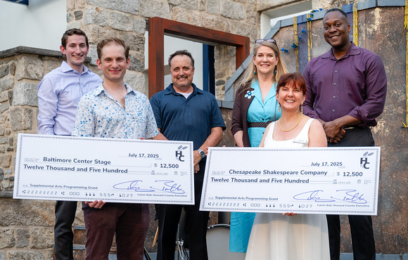 A photo of County Executive Calvin Ball and Howard County Arts Council Executive Director Coleen West with representatives from Baltimore Center Stage and Chesapeake Shakespeare Company their $12,500 checks for a one-time supplemental arts programming grant they were awarded.