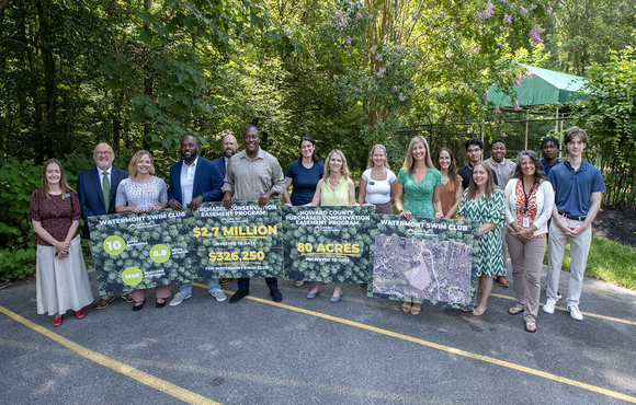 A photo of County Executive Calvin Ball and representatives from the Howard County Conservancy and Watermont Swim Club to annouce the announce the completion of the third land preservation easement through the Purchased Conservation Easement Program.
