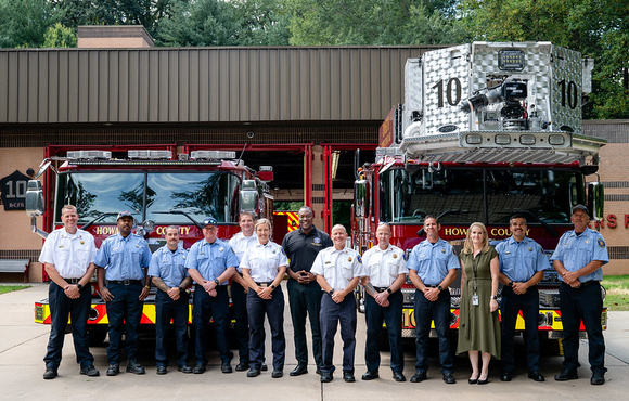 A photo of County Executive Calvin Ball with firefighters out front of Station 10.