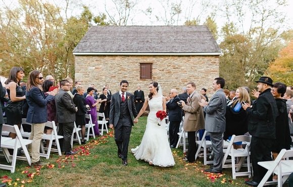 A newly wed couple walking down the aisle after their ceremony at Waverly Mansion. 