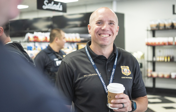 Officer smiling with a cup of coffee