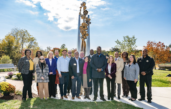 A photo of County Executive Calvin Ball and others at the unveiling of the new bronze and stainless steel sculpture at the County’s COVID-19 memorial at the Meadowbrook Park in Ellicott City.