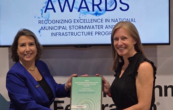 A photo of Office of Community Sustainability Stormwater Programs Manager Lindsay DeMarzo receiving WEF's MSF Phase I Innovation award at its annual conference in Chicago. 