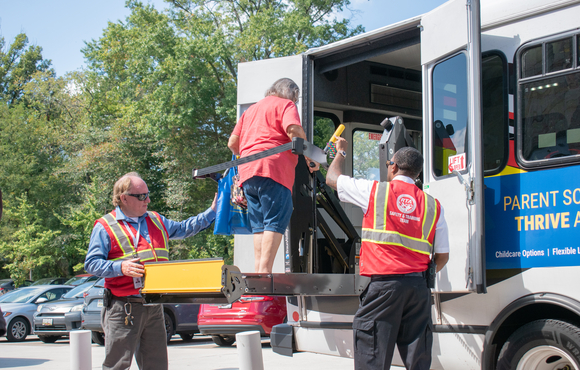 Female older adult testing out public transit lift