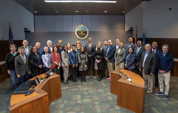 A photo of County Executive Calvin Ball with members of his Economic Competitiveness and Opportunity Now Task Force at his press conference announcing the release of the Task Force's report.