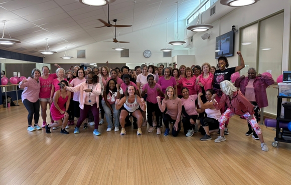 group of women posing in their pink workout clothing