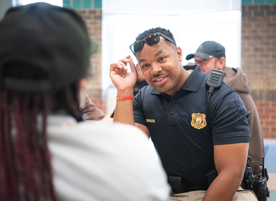 Officer talking with high schooler