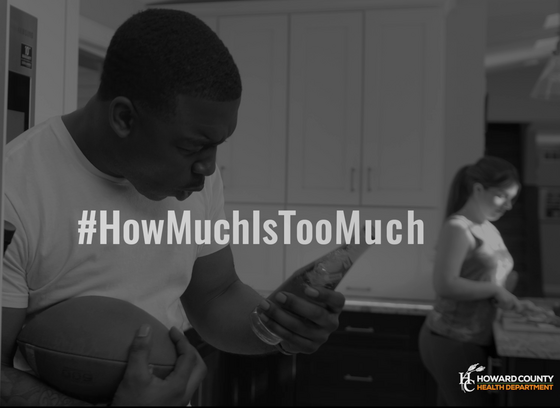 Man holding a beer bottle. Tagline: #HowMuchIsTooMuch