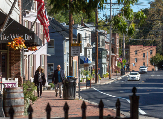 An older couple walking down Ellicott City's Main Street.