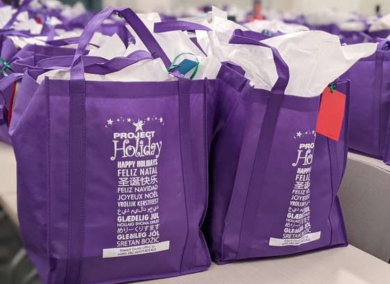 Two stuffed Project Holiday gift bags ready to be delivered.