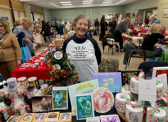 Older adult at market selling crafts