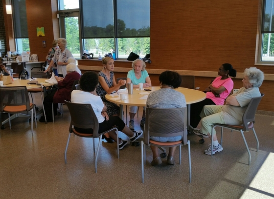 Older adults discussing around a table