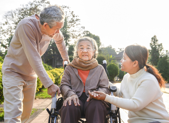 Group of older adults and woman in wheelchair 