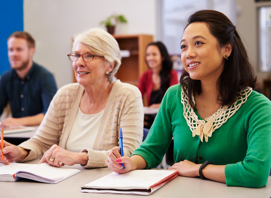 two adults in a room setting learning