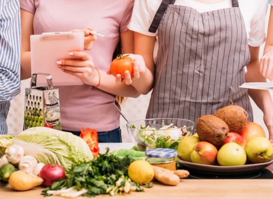 group of people looking at food and taking notes