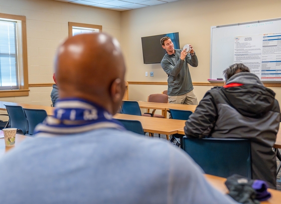 Firefighter demonstrates smoke alarm