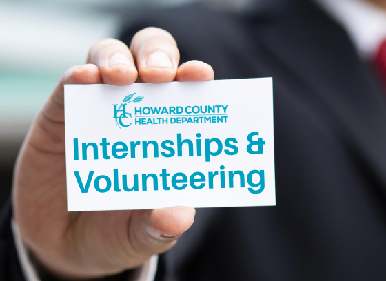 Hand holding a card that says internships and volunteering.