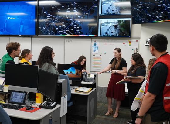 Office of emergency management staff huddled together for a meeting