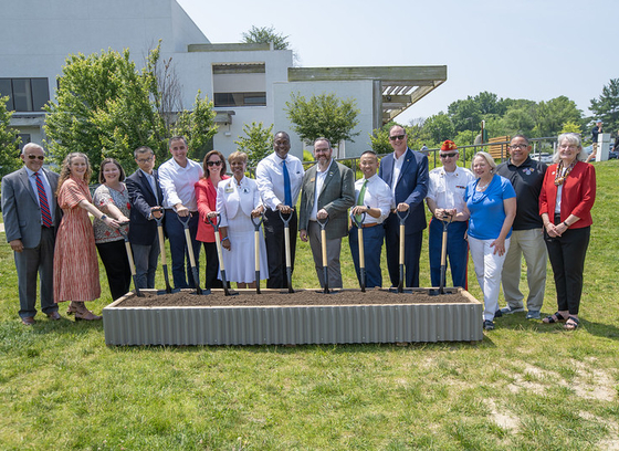 A photo of County Executive Calvin Ball and attendees ready to break ground on Howard County's new Veterans and Military Family Monument.