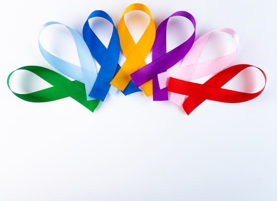 multiple colored cancer awareness ribbons on a white background