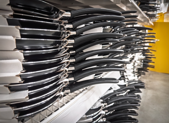 Rows of nonstick pancake pans with long black handles