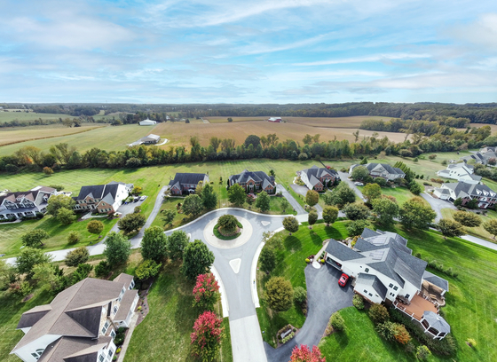 Aerial photo of residential development with forested and agricultural land nearby
